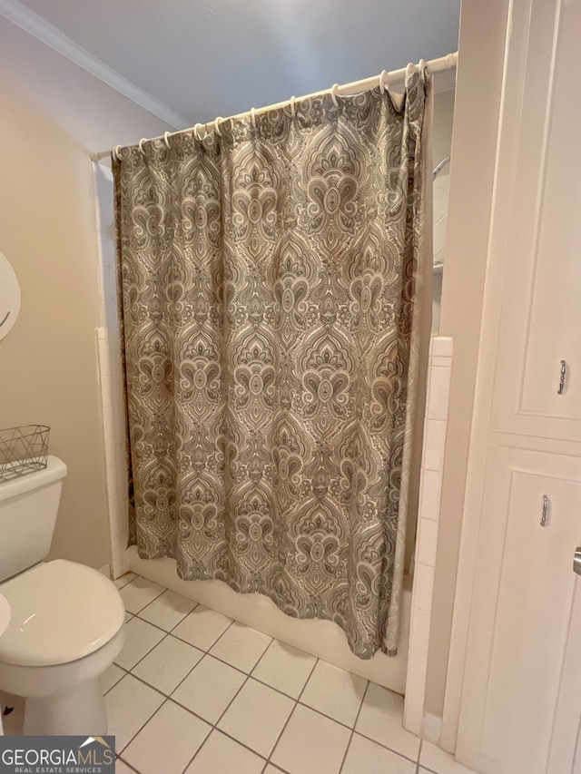 full bathroom featuring tile patterned floors, shower / bath combination with curtain, and toilet