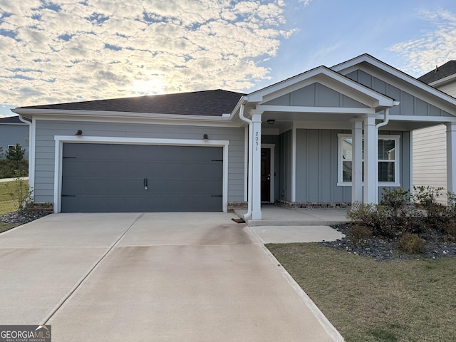 2051 Blue Sky Ave, Covington, GA 30016 - ranch-style home with board and batten siding, driveway, an attached garage, and covered porch
