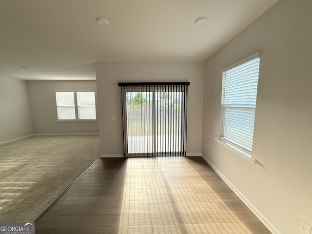 2051 Blue Sky Ave, Covington, GA 30016 - spare room featuring healthy amount of natural light, wood finished floors, and baseboards