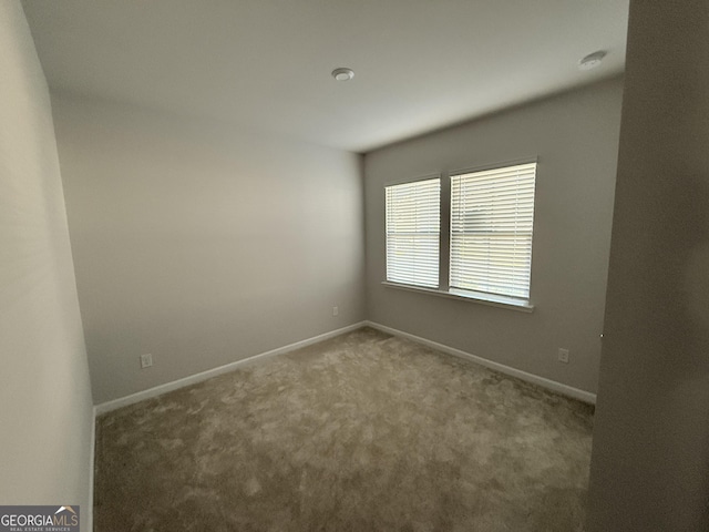 2051 Blue Sky Ave, Covington, GA 30016 - spare room featuring carpet floors and baseboards