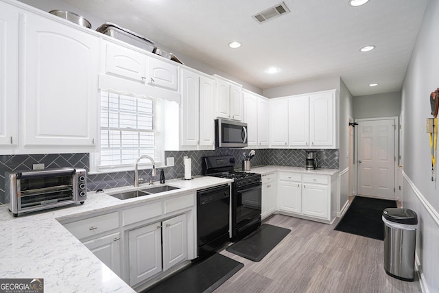 1010 Capella Creek Way, Grayson, GA 30017 - kitchen featuring a sink, black appliances, white cabinetry, and recessed lighting