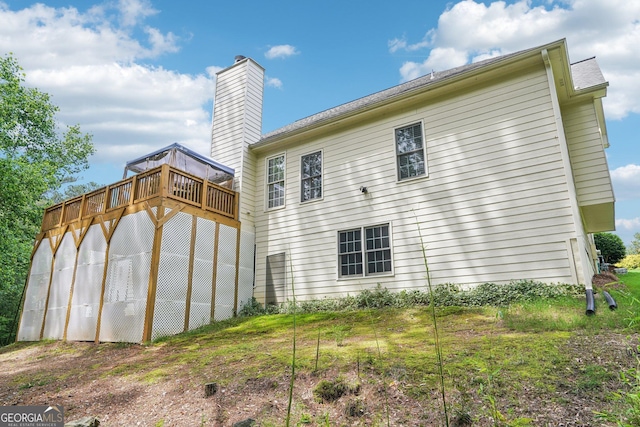 1010 Capella Creek Way, Grayson, GA 30017 - back of house featuring a wooden deck and a chimney
