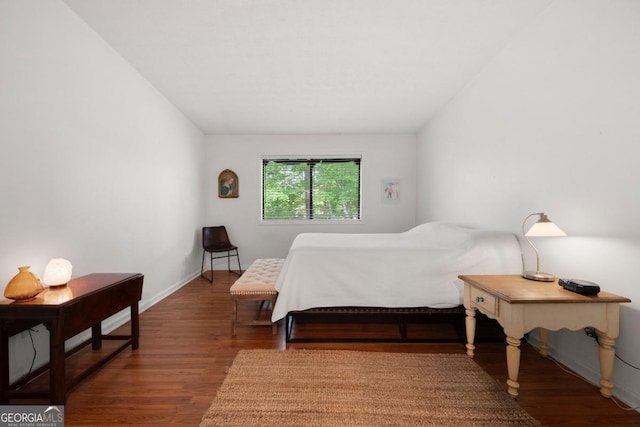bedroom featuring wood finished floors and baseboards