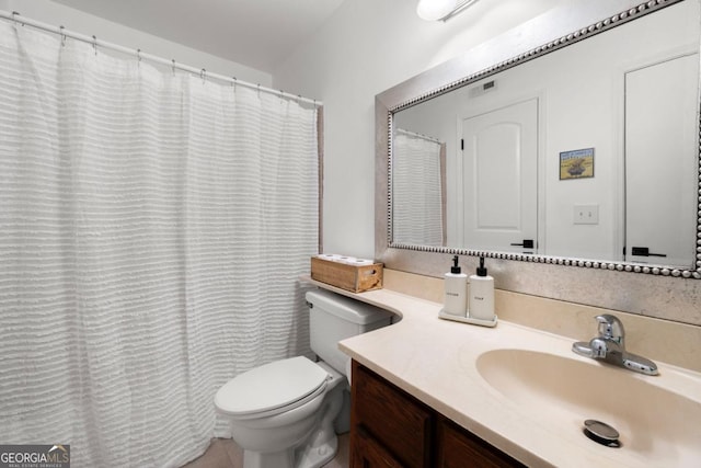 full bath featuring vanity and toilet