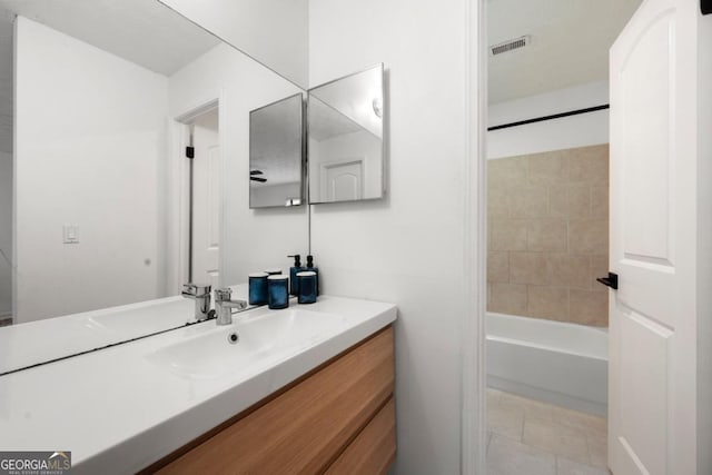 bathroom featuring vanity, tile patterned flooring, and tub / shower combination