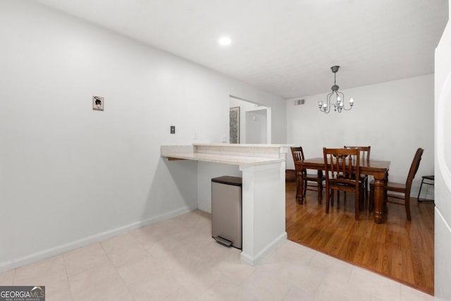 dining space featuring a chandelier, baseboards, and recessed lighting