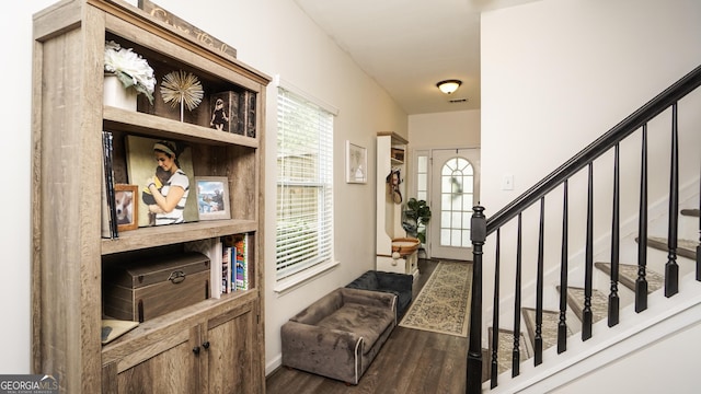 entryway featuring stairway, wood finished floors, and baseboards