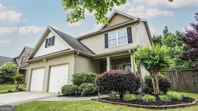 view of front of property with fence, concrete driveway, an attached garage, board and batten siding, and a porch