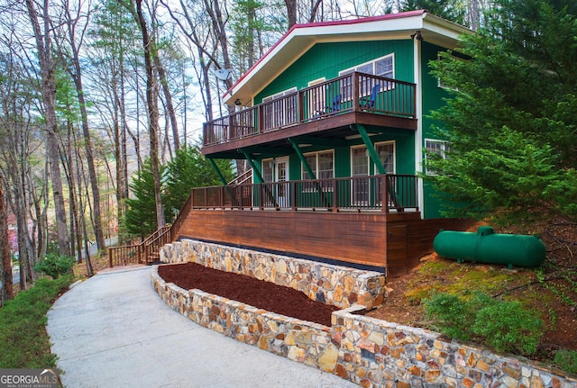 view of front facade featuring stairway and a wooden deck