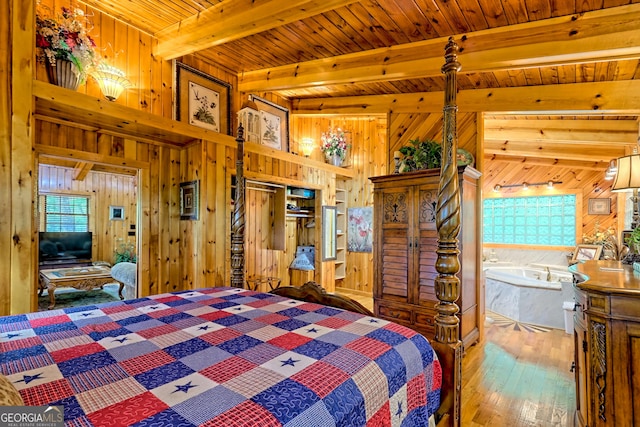 bedroom with wood walls, hardwood / wood-style floors, multiple windows, beam ceiling, and wooden ceiling