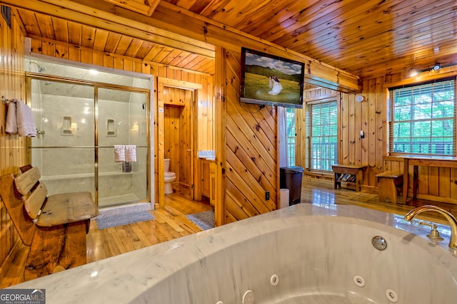 full bath with a stall shower, a whirlpool tub, toilet, wood finished floors, and wood ceiling