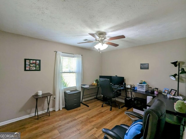 2003 Brenda Ln, Vidalia, GA 30474 - home office featuring light wood finished floors, ceiling fan, a textured ceiling, baseboard heating, and baseboards
