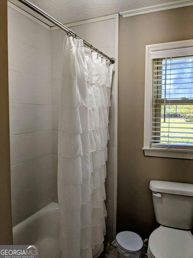 2003 Brenda Ln, Vidalia, GA 30474 - bathroom featuring ornamental molding, a textured ceiling, and toilet