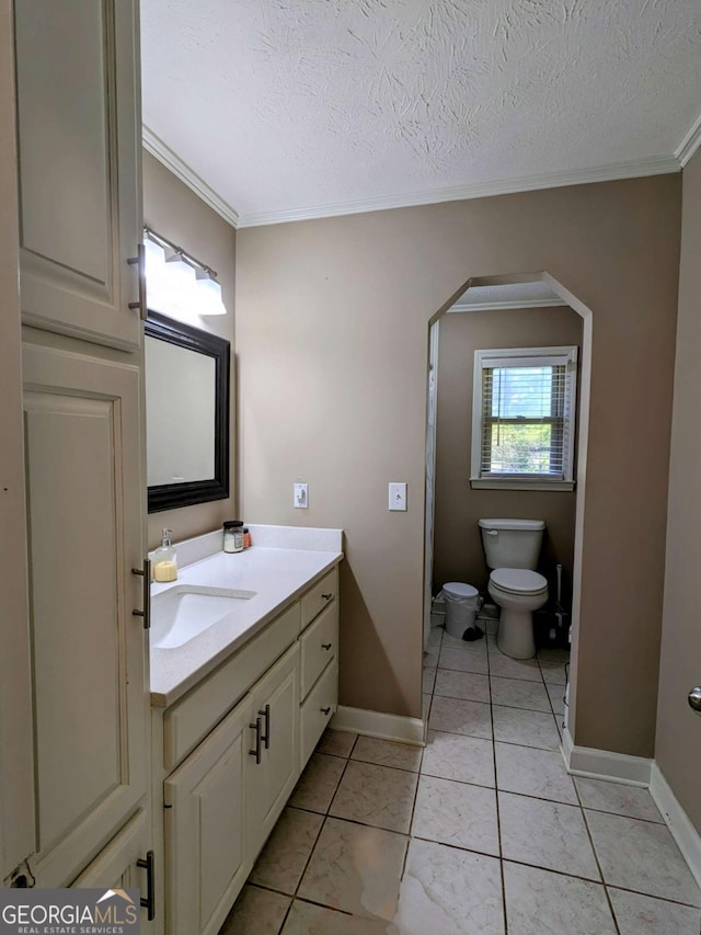 2003 Brenda Ln, Vidalia, GA 30474 - bathroom with ornamental molding, toilet, vanity, baseboards, and a textured ceiling