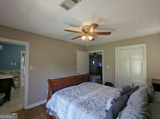 2003 Brenda Ln, Vidalia, GA 30474 - bedroom with a closet, a ceiling fan, light wood-style floors, a sink, and connected bathroom