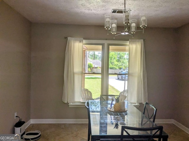 2003 Brenda Ln, Vidalia, GA 30474 - tiled dining area with a chandelier, baseboards, and a textured ceiling