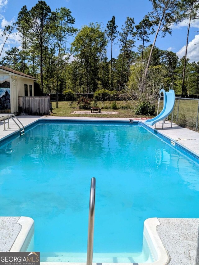 2003 Brenda Ln, Vidalia, GA 30474 - view of pool with a water slide and fence