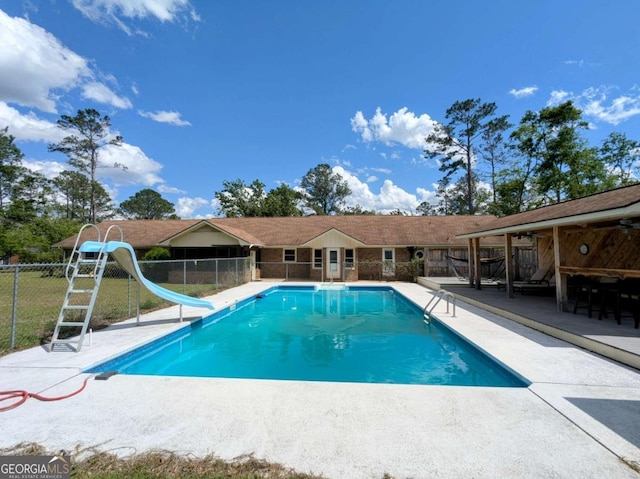 2003 Brenda Ln, Vidalia, GA 30474 - swimming pool featuring fence, a water slide, and a patio