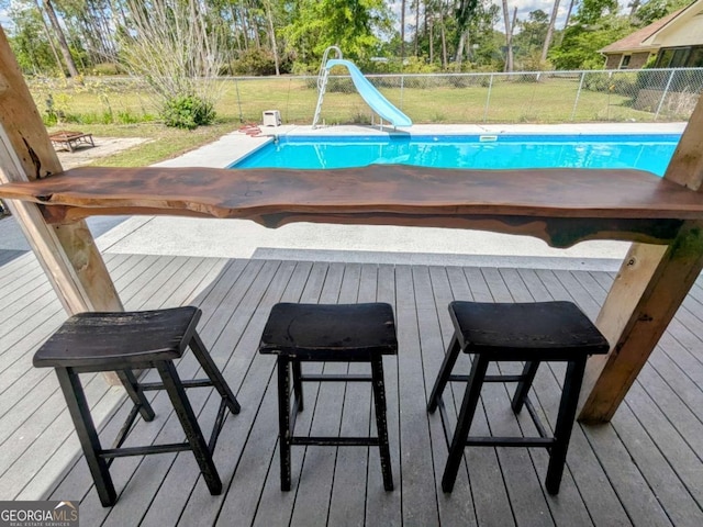 2003 Brenda Ln, Vidalia, GA 30474 - view of swimming pool featuring a wooden deck and a water slide