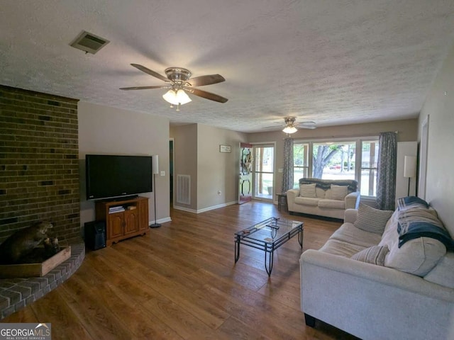 2003 Brenda Ln, Vidalia, GA 30474 - living area featuring a textured ceiling, wood finished floors, ceiling fan, and baseboards