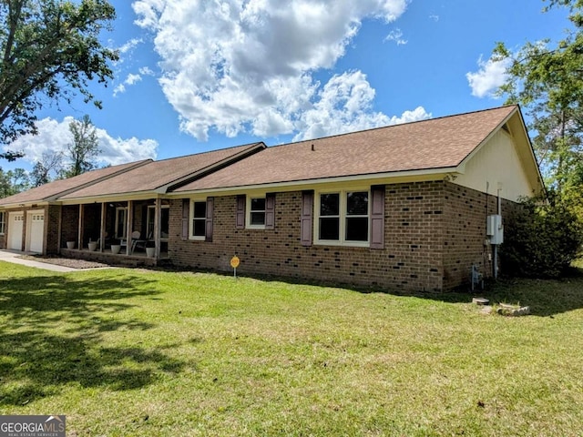 2003 Brenda Ln, Vidalia, GA 30474 - rear view of property featuring an attached garage, a yard, and brick siding