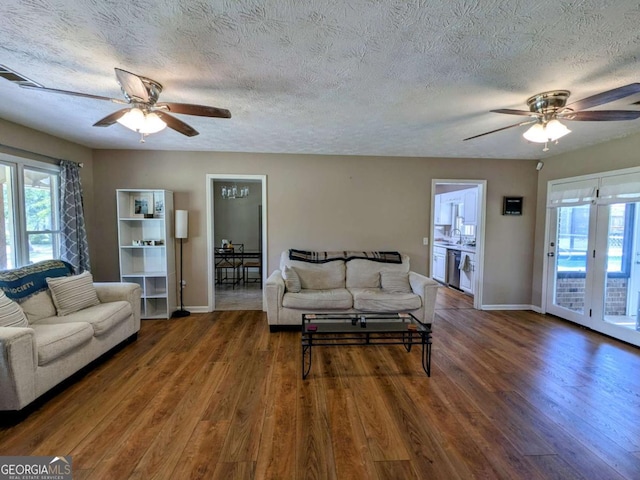 2003 Brenda Ln, Vidalia, GA 30474 - living room with ceiling fan, baseboards, wood finished floors, plenty of natural light, and a textured ceiling