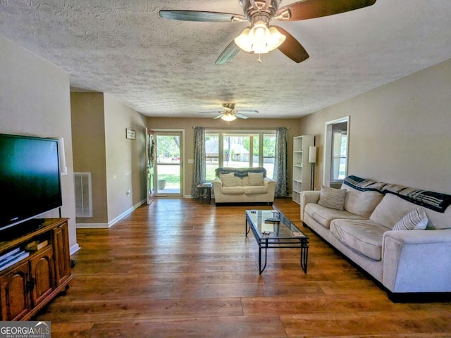 2003 Brenda Ln, Vidalia, GA 30474 - living room featuring a ceiling fan, wood finished floors, baseboards, and a textured ceiling