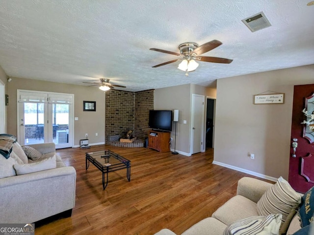 2003 Brenda Ln, Vidalia, GA 30474 - living area featuring a textured ceiling, a ceiling fan, baseboards, and wood finished floors