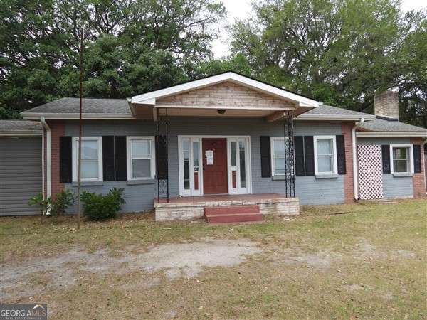 410 Live Oak Church Rd, Hinesville, GA 31313 - view of front of home with a chimney, a porch, and brick siding