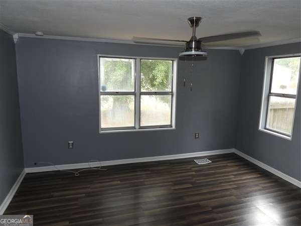 410 Live Oak Church Rd, Hinesville, GA 31313 - unfurnished room with crown molding, dark wood finished floors, baseboards, and a ceiling fan