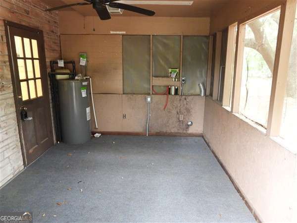 410 Live Oak Church Rd, Hinesville, GA 31313 - unfurnished sunroom featuring water heater