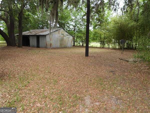 410 Live Oak Church Rd, Hinesville, GA 31313 - view of yard featuring an outbuilding and an outdoor structure