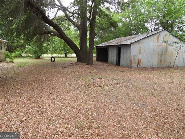410 Live Oak Church Rd, Hinesville, GA 31313 - view of yard with an outdoor structure and an outbuilding
