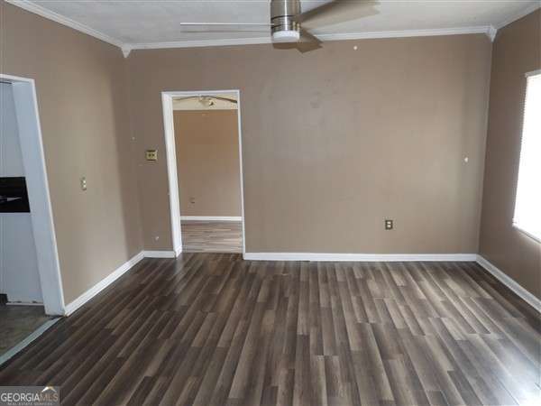 410 Live Oak Church Rd, Hinesville, GA 31313 - unfurnished room featuring crown molding, ceiling fan, baseboards, and wood finished floors