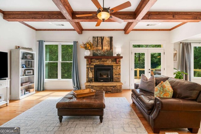 living room featuring coffered ceiling, wood finished floors, beamed ceiling, ceiling fan, and french doors