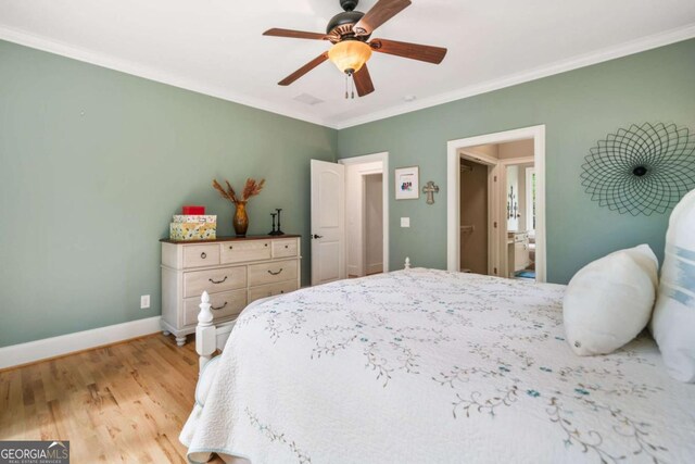 bedroom with ornamental molding, light wood-style floors, baseboards, a ceiling fan, and ensuite bathroom
