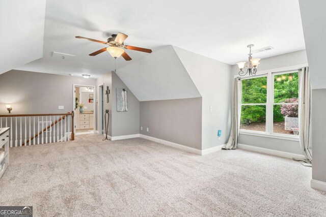 additional living space with ceiling fan, carpet, baseboards, a chandelier, and lofted ceiling