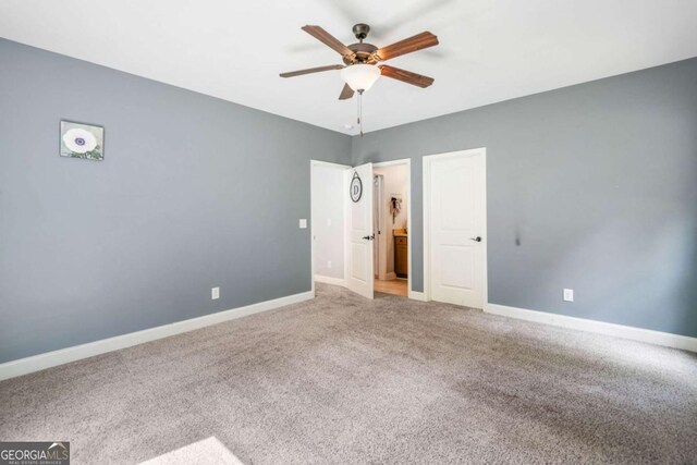 unfurnished bedroom featuring baseboards, carpet floors, and ceiling fan