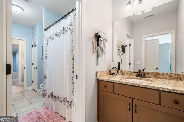 bathroom with tile patterned floors, vanity, a shower with curtain, and baseboards
