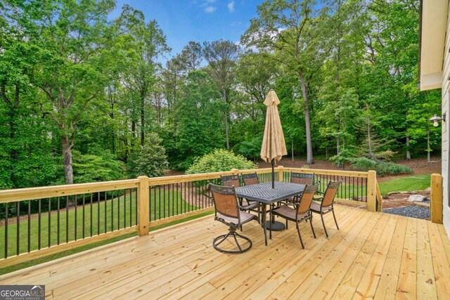 wooden terrace featuring outdoor dining space