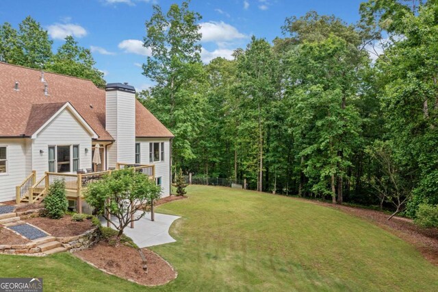 view of yard with a wooden deck and a patio area