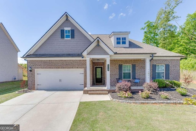 craftsman house featuring brick siding, covered porch, and a front lawn