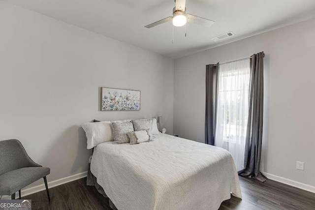 bedroom with baseboards, dark wood-style flooring, and ceiling fan