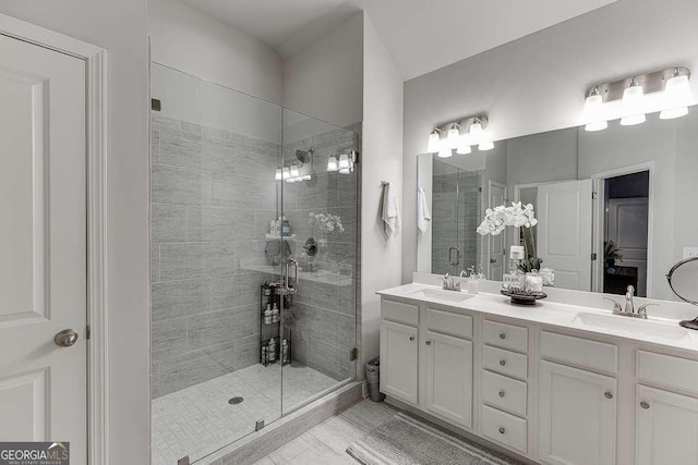 full bath featuring a shower stall and double vanity