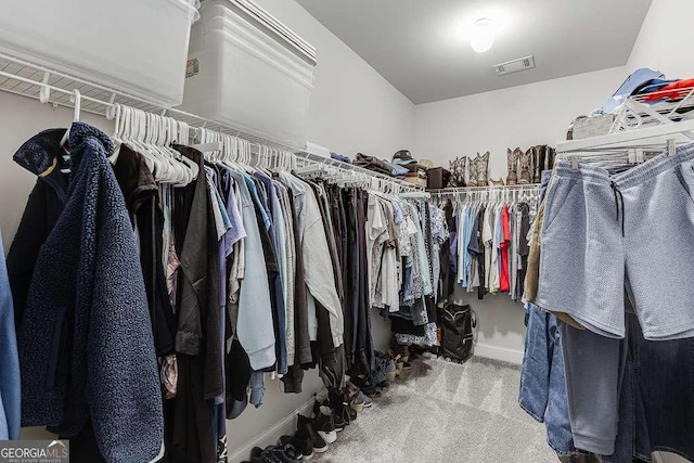 walk in closet with carpet floors