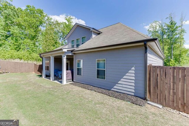rear view of property featuring a patio area