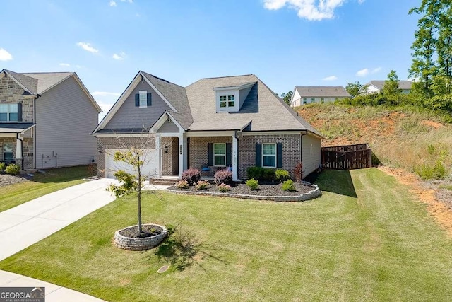 craftsman-style house with brick siding, driveway, covered porch, and an attached garage