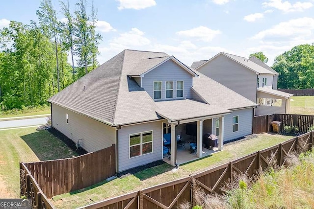 back of house with a patio and a shingled roof