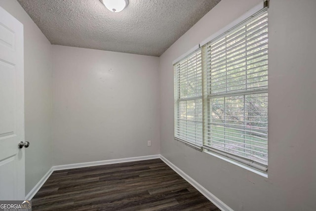 2800 Macon Dr SE, Atlanta, GA 30354 - empty room with a textured ceiling, dark wood-style flooring, and baseboards
