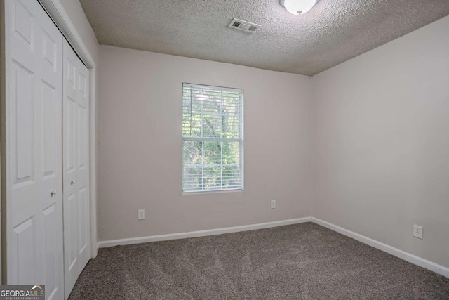 2800 Macon Dr SE, Atlanta, GA 30354 - unfurnished bedroom featuring a textured ceiling, carpet floors, a closet, and baseboards